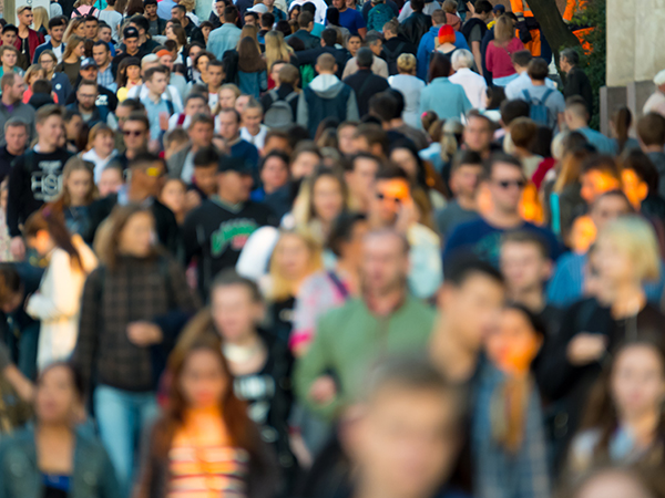 Aerial photo of busy sidewalk, wall to wall people