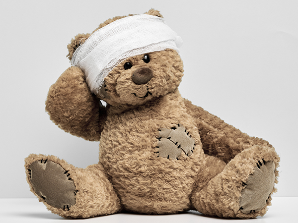 Teddy bear with bandage on it's head