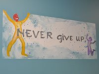 Marzelle Never Give Up Signage